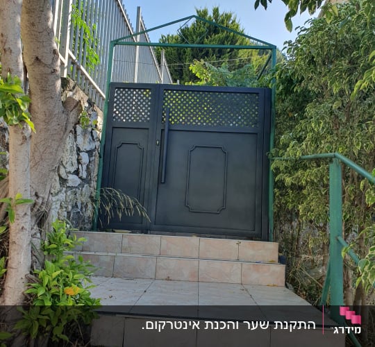 שער מתכת שחור עם מסגרת ירוקה
